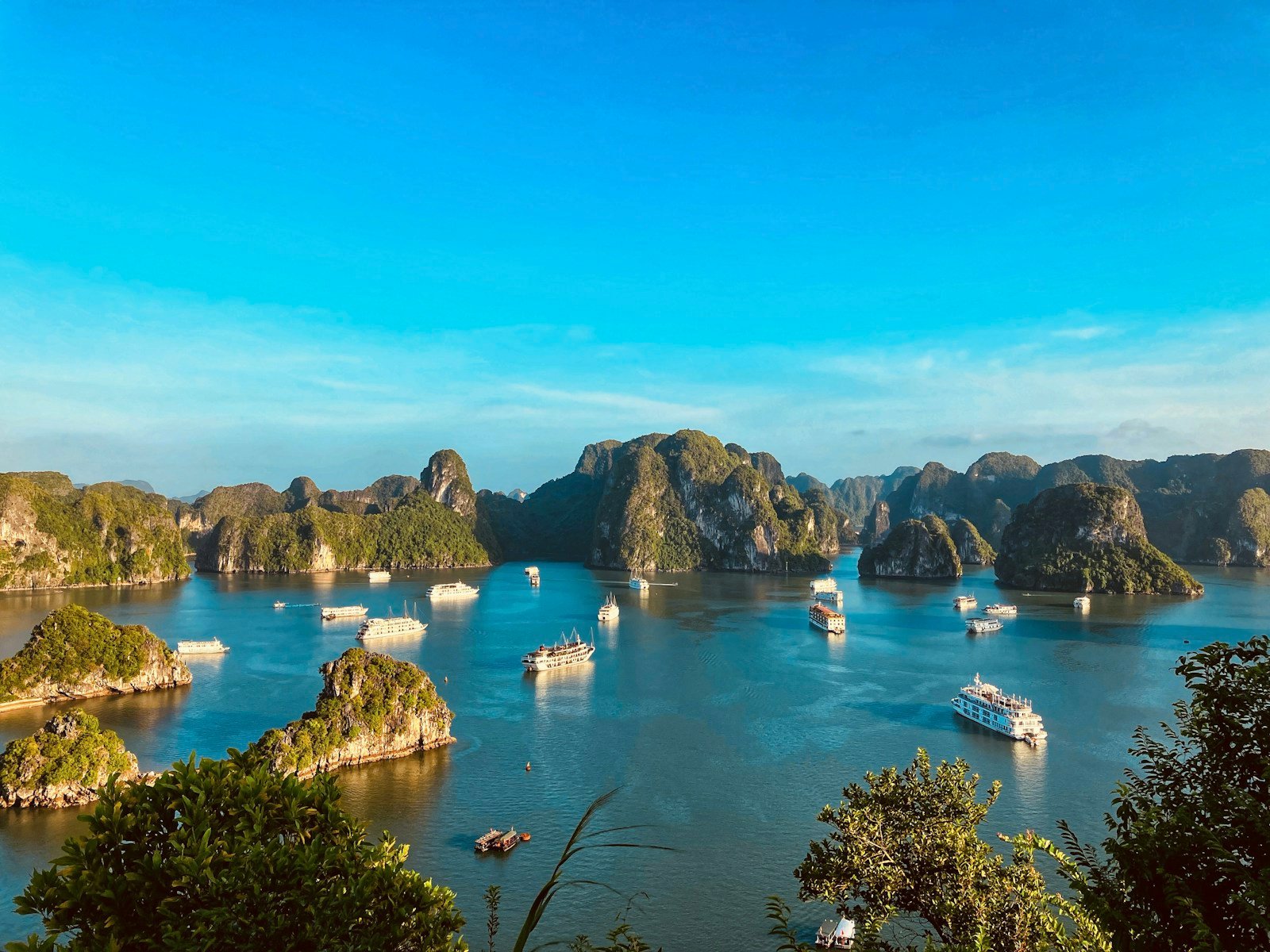Cruise boats among limestone islands in Ha Long Bay, Vietnam.